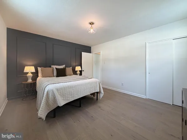 a bedroom with a bed and a night stand