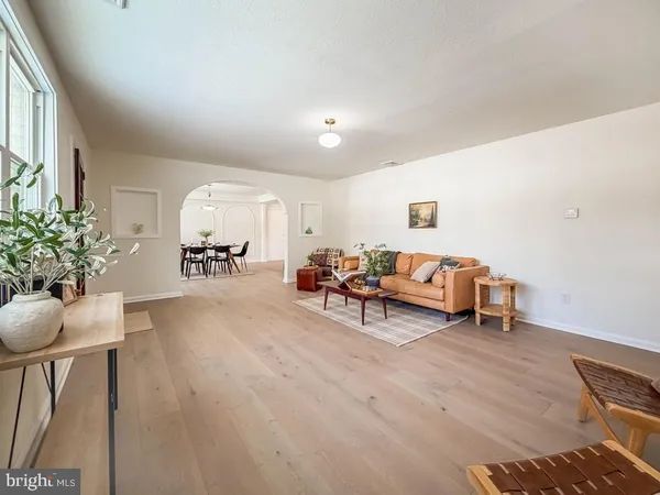 a living room with furniture and flowers