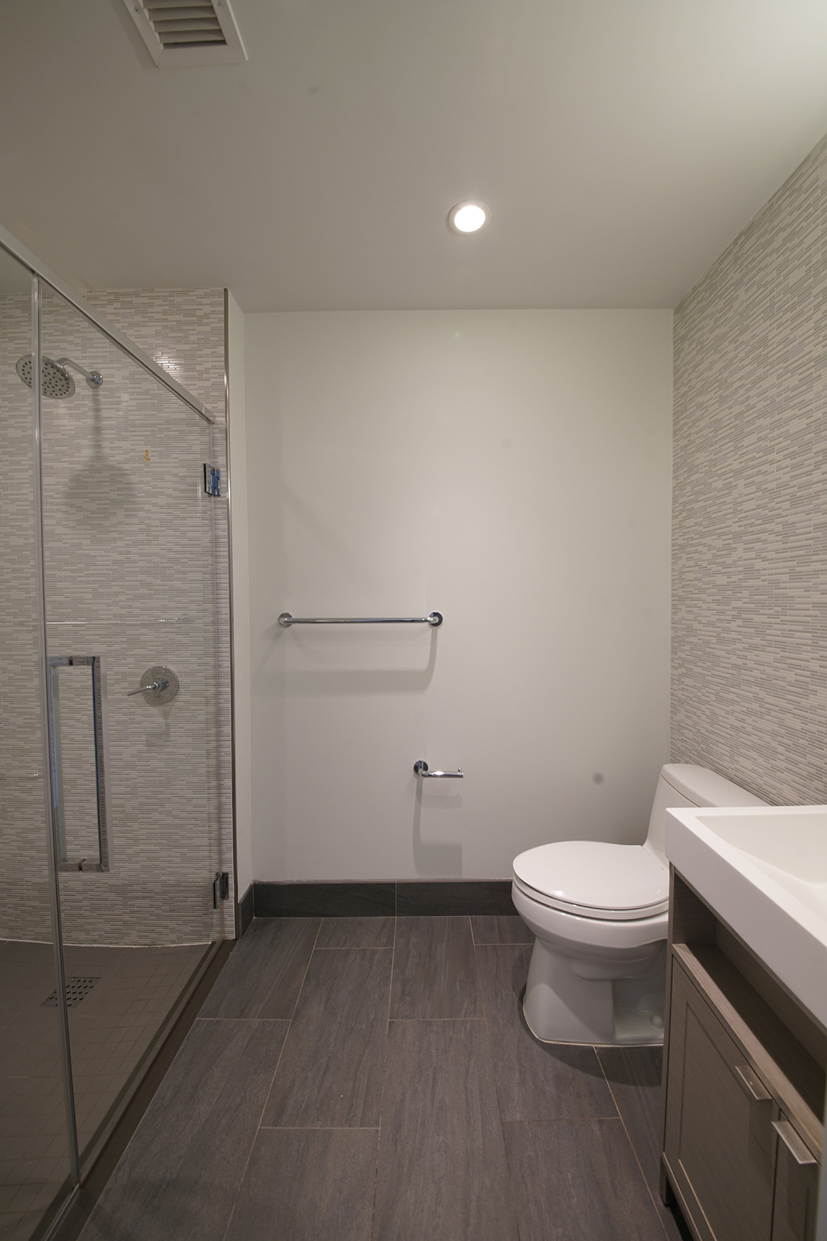 555 10th Avenue, Unit 41M Manhattan, NY 10018 - Photo 7 of 20 a bathroom with a toilet and a shower