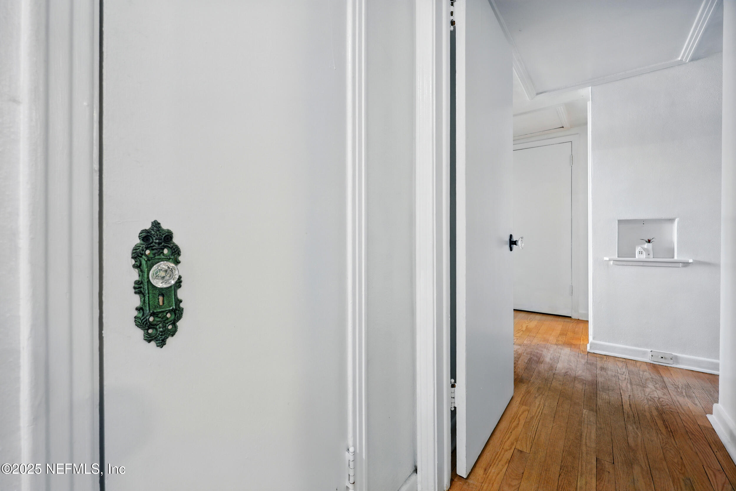 6414 Colgate Road Jacksonville, FL 32217 - Photo 12 of 33 a view of a hallway with wooden floor and a bathroom