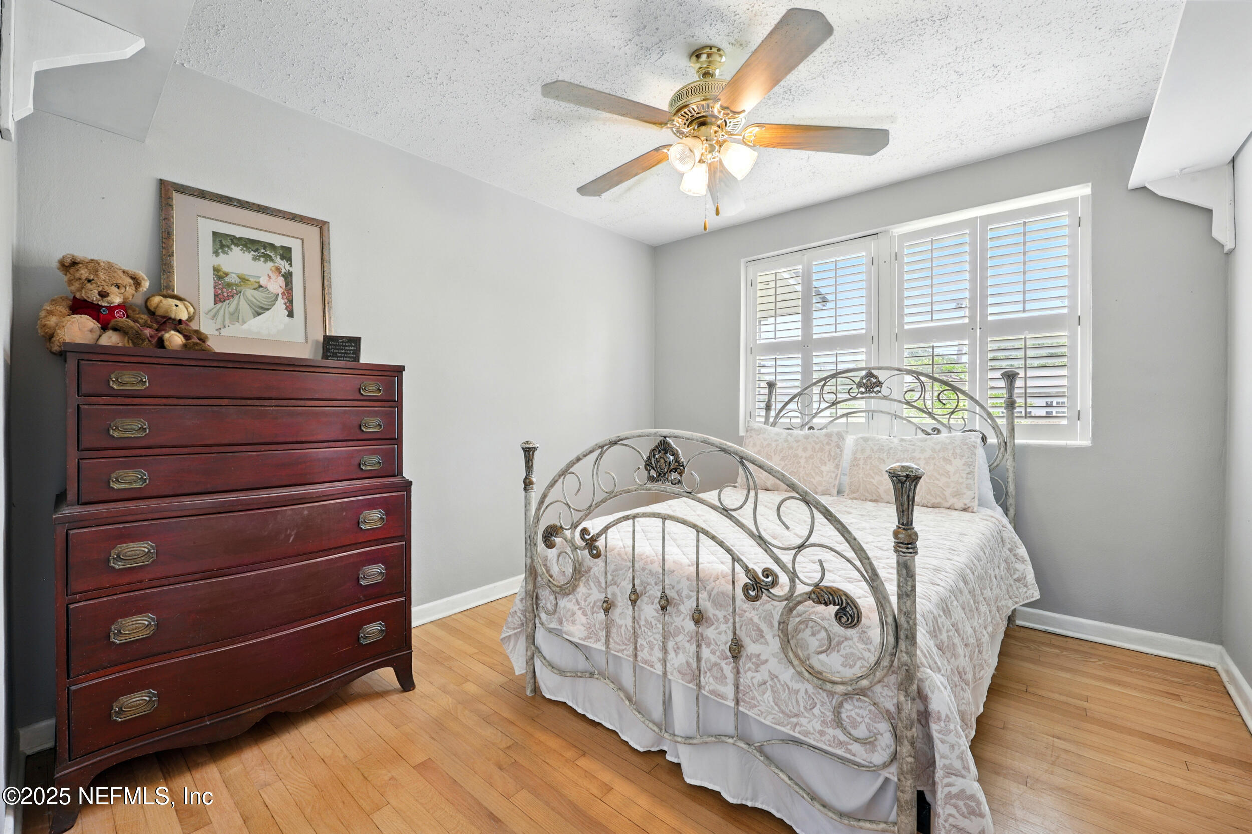 6414 Colgate Road Jacksonville, FL 32217 - Photo 19 of 33 a bedroom with a bed and a chandelier