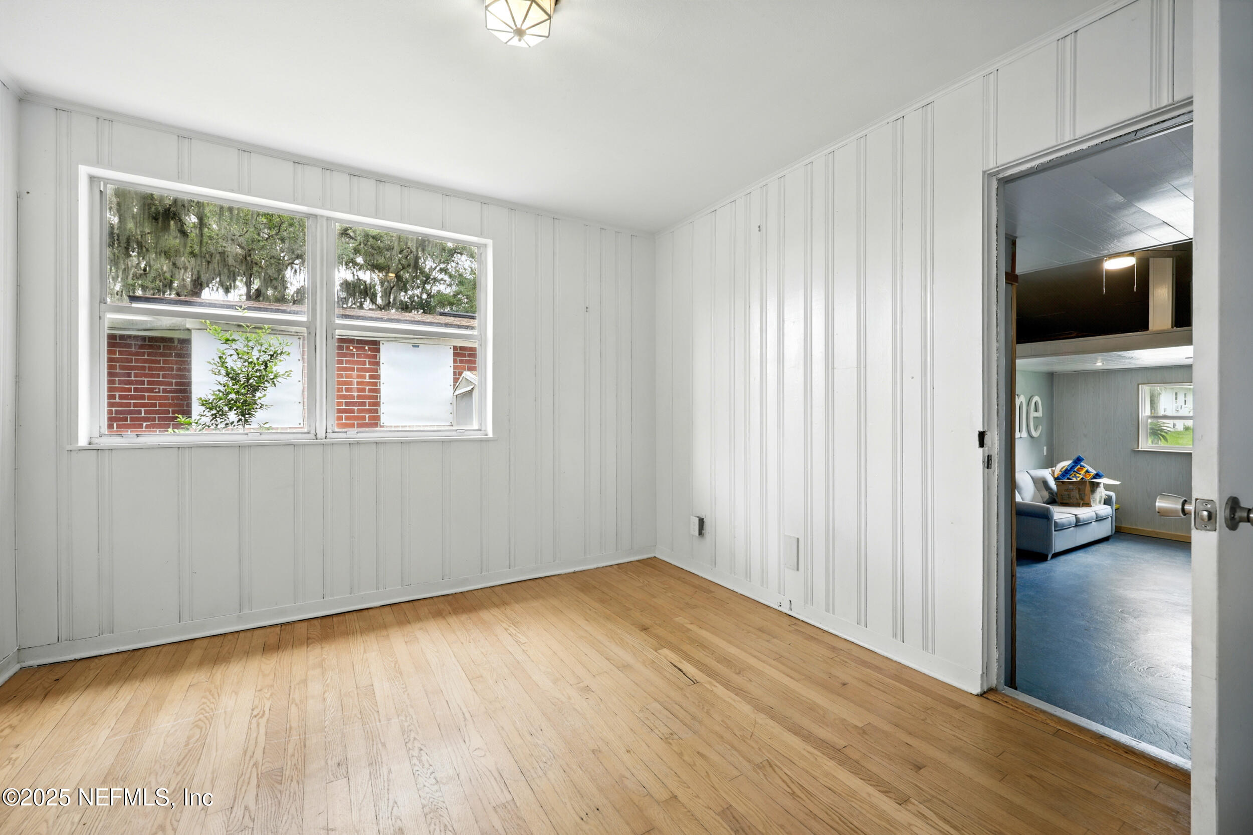 6414 Colgate Road Jacksonville, FL 32217 - Photo 20 of 33 a view of empty room with a window and wooden floor