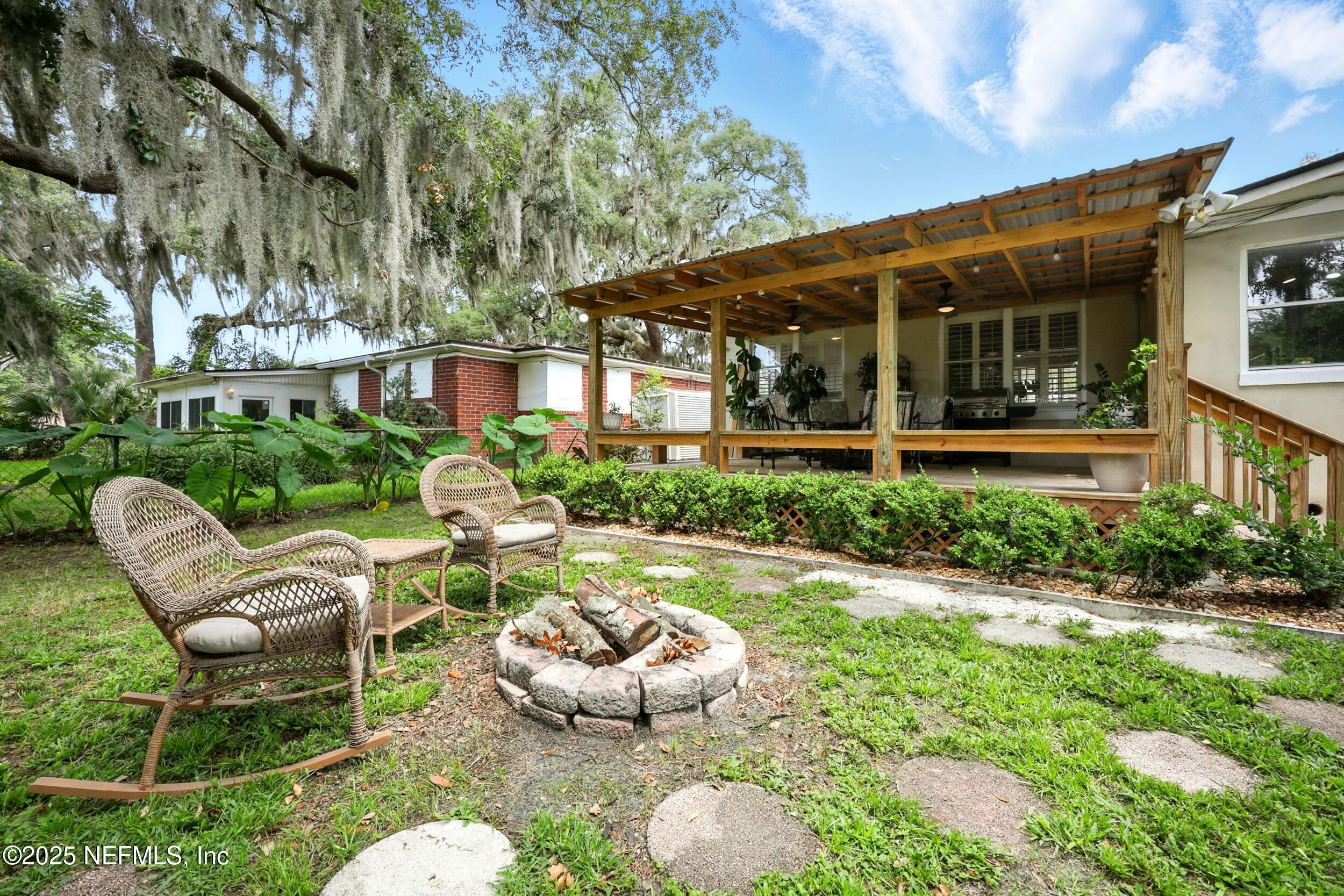 6414 Colgate Road Jacksonville, FL 32217 - Photo 29 of 33 a view of a patio with couches table and chairs potted plants and large tree