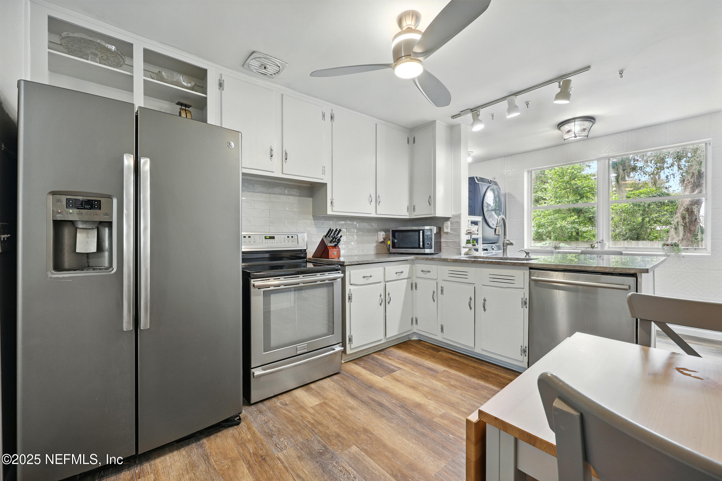 6414 Colgate Road Jacksonville, FL 32217 - Photo 3 of 33 a kitchen with a refrigerator cabinets and wooden floor