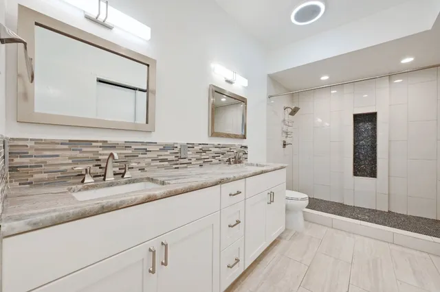 a spacious bedroom with a bed and a table in it