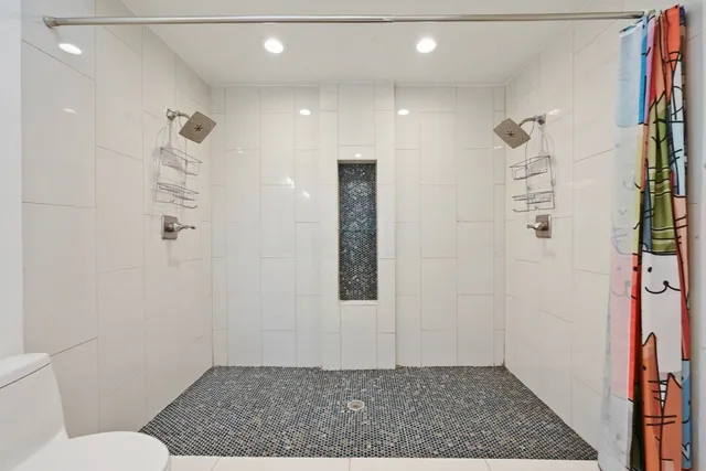 a spacious bathroom with a granite countertop sink mirror and a