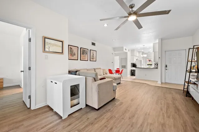 a living room with furniture and a wooden floor