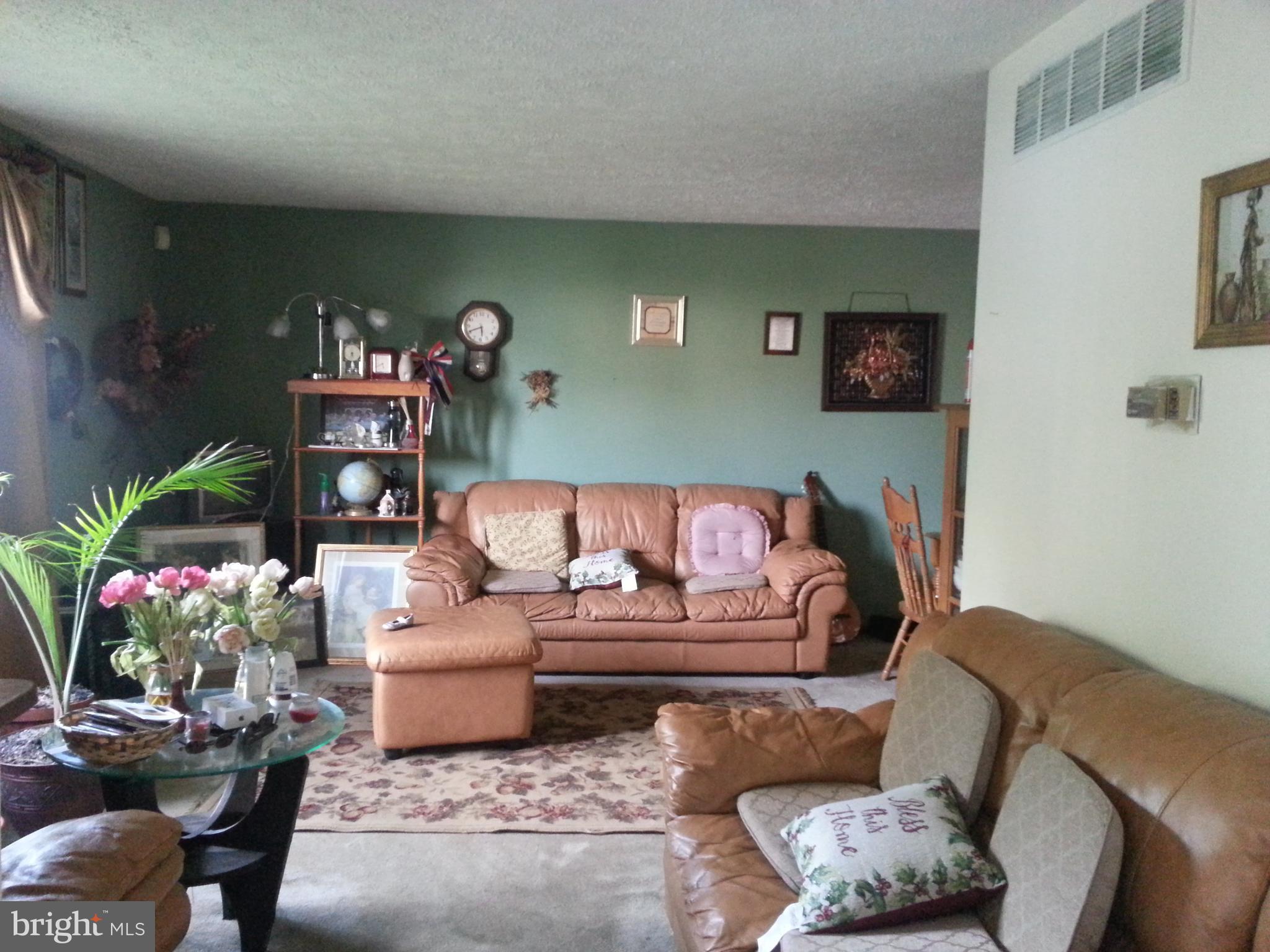 a living room with furniture and flowers