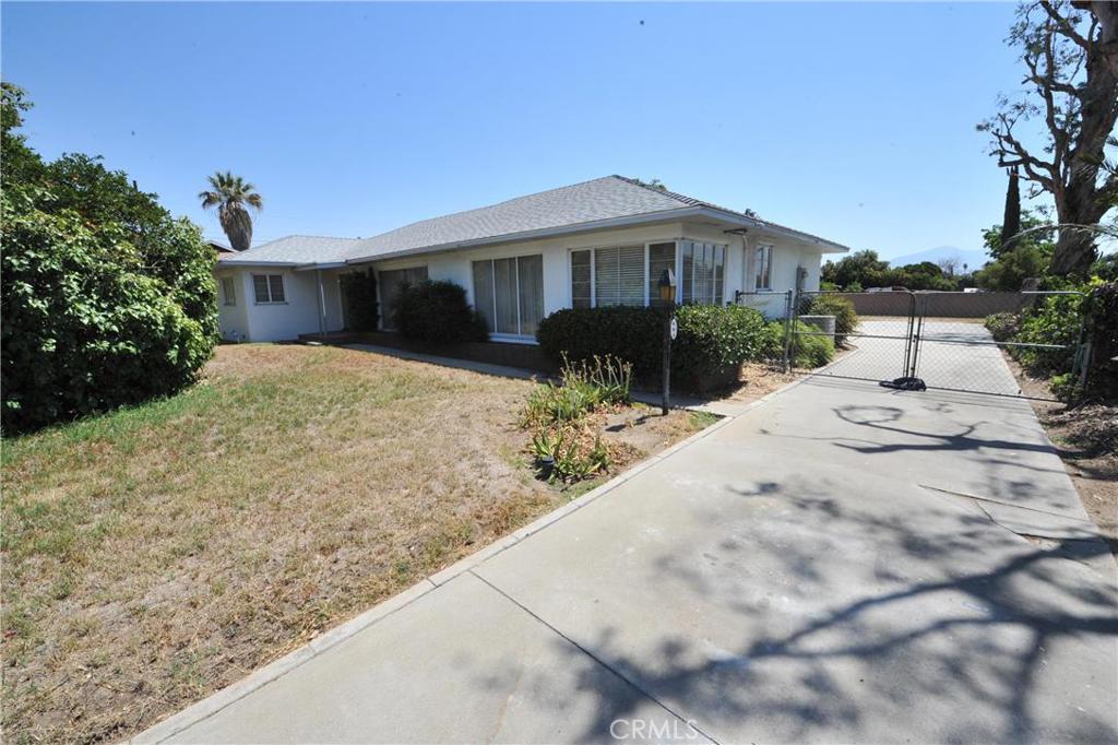601 North Riverside Avenue Rialto, CA 92376 - Photo 1 of 1 a front view of house with yard and trees in the background