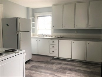 40 June Street Worcester, MA 01602 - Photo 24 of 28 a kitchen with granite countertop cabinets appliances a sink and a window