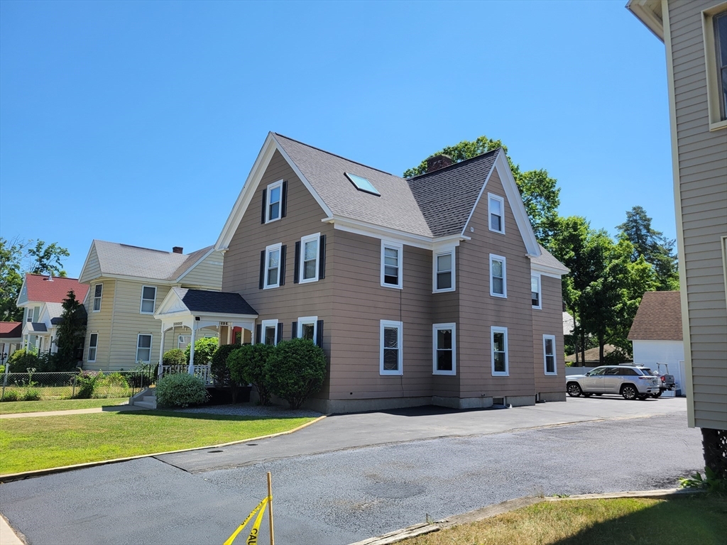 40 June Street Worcester, MA 01602 - Photo 7 of 28 a front view of a house with a yard and garage