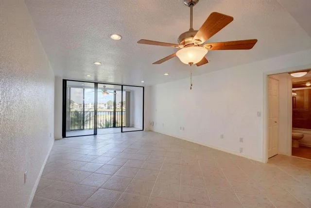 a kitchen with stainless steel appliances granite countertop a stove a sink and a refrigerator with wooden cabinets