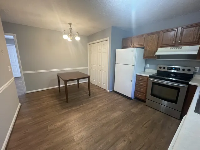 a kitchen with a stove and a refrigerator
