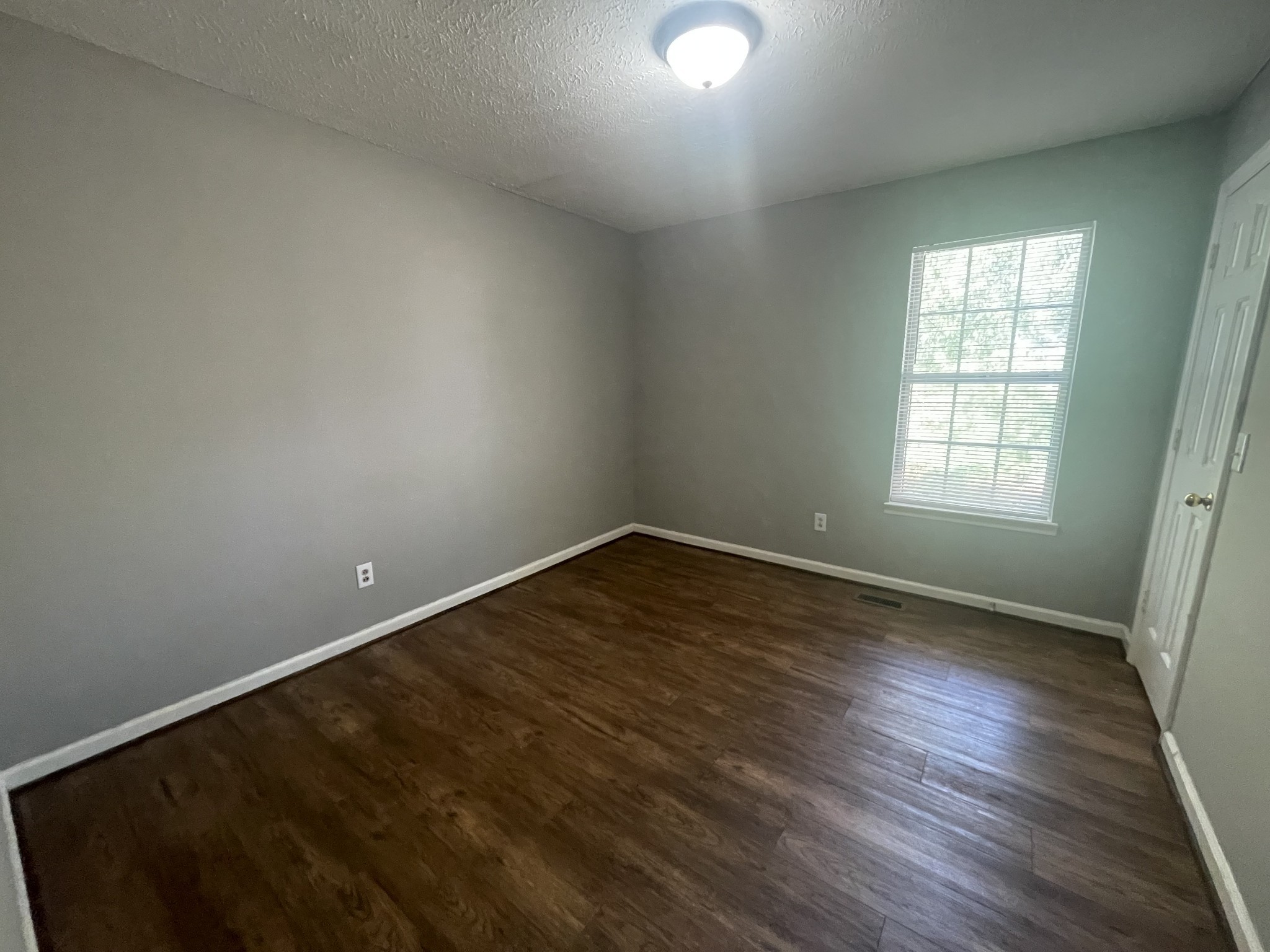 2505 Tinnell Court, Unit 2505 Murfreesboro, TN 37129 - Photo 5 of 11 an empty room with wooden floor and windows