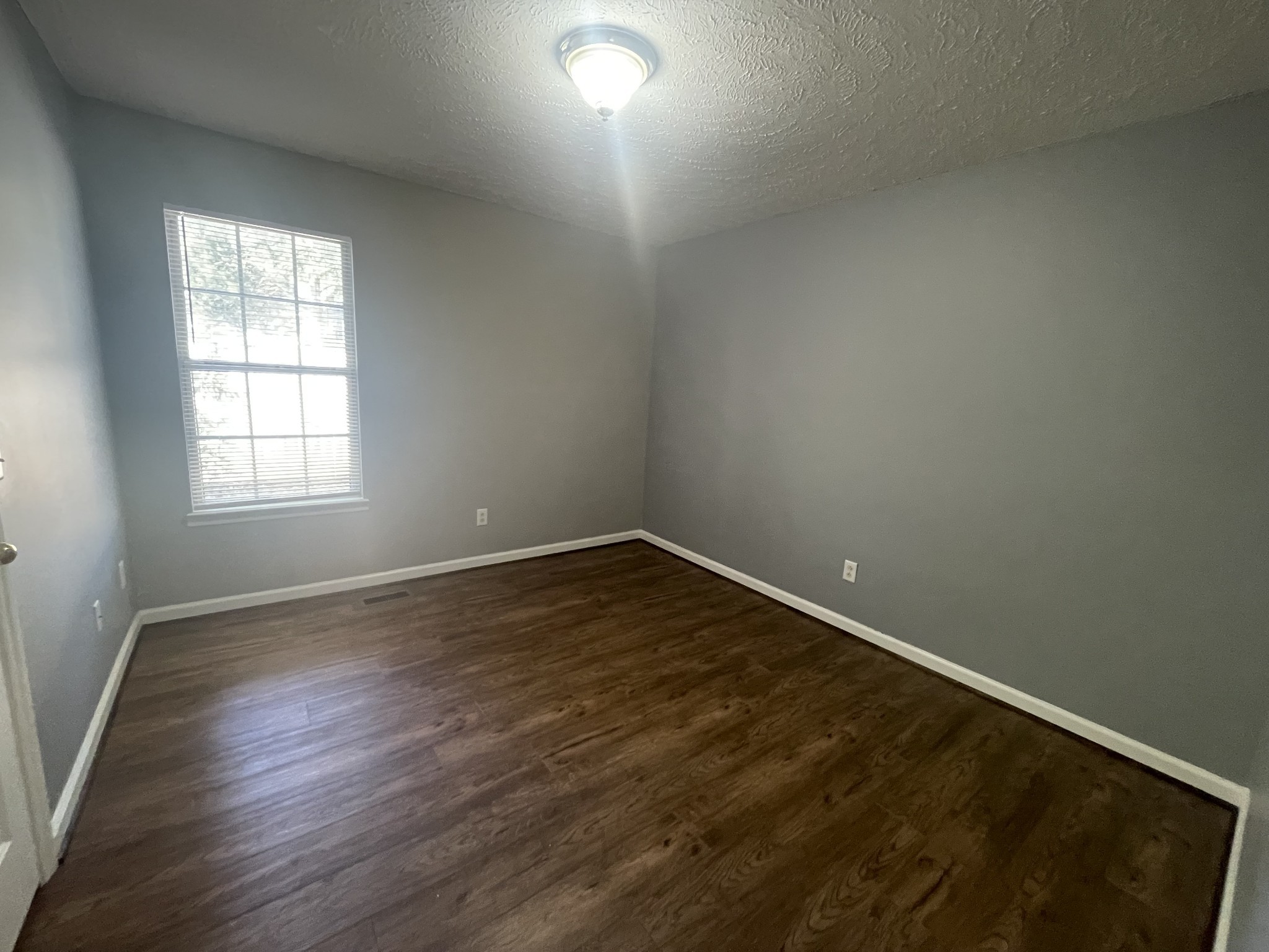 2505 Tinnell Court, Unit 2505 Murfreesboro, TN 37129 - Photo 8 of 11 an empty room with wooden floor and windows