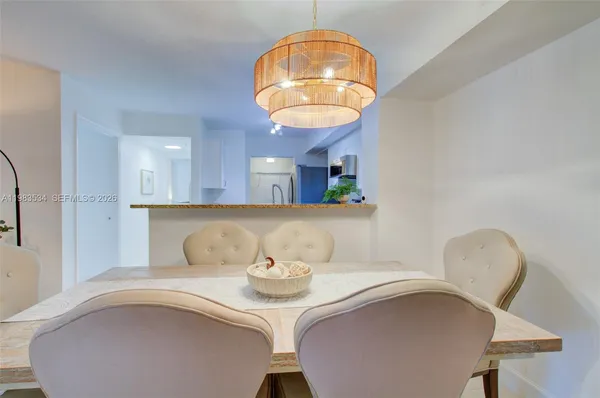 a kitchen with a table chairs and a wooden floor