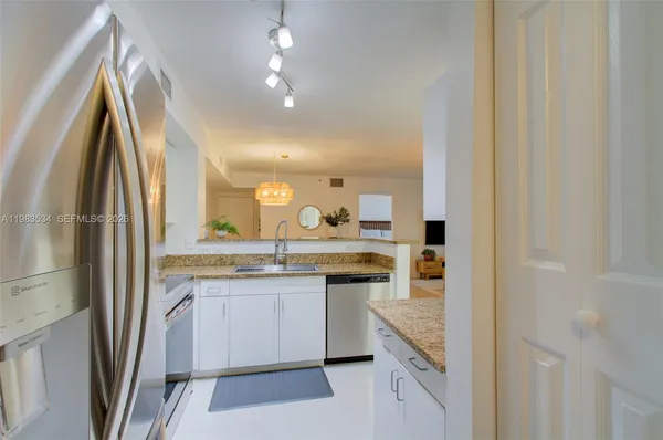 a kitchen with a sink and refrigerator