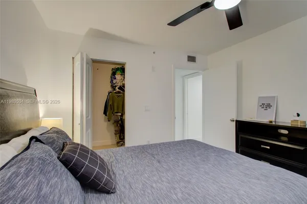 a bedroom with a bed and a television