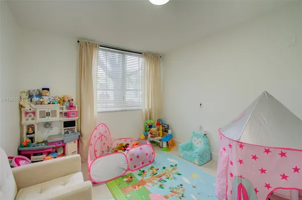 a bedroom with baby toys and a dresser