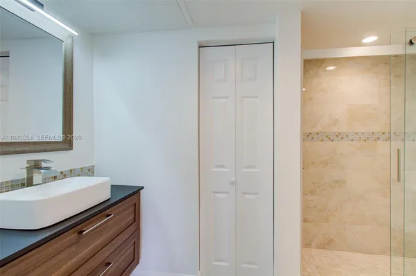 a bathroom with a shower a toilet and a sink