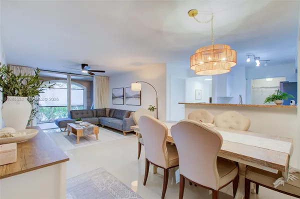 a view of a dining room with furniture and chandelier