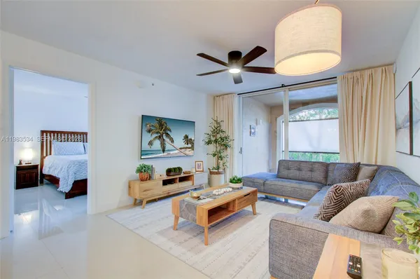 a living room with furniture and a large window