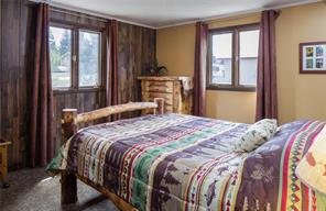 361 Lagoon Lane Silverthorne, CO 80498 - Photo 10 of 24 a bedroom with a bed and large windows