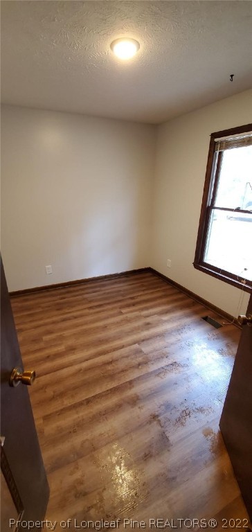 1750 Rim Road Fayetteville, NC 28314 - Photo 13 of 22 an empty room with wooden floor and windows