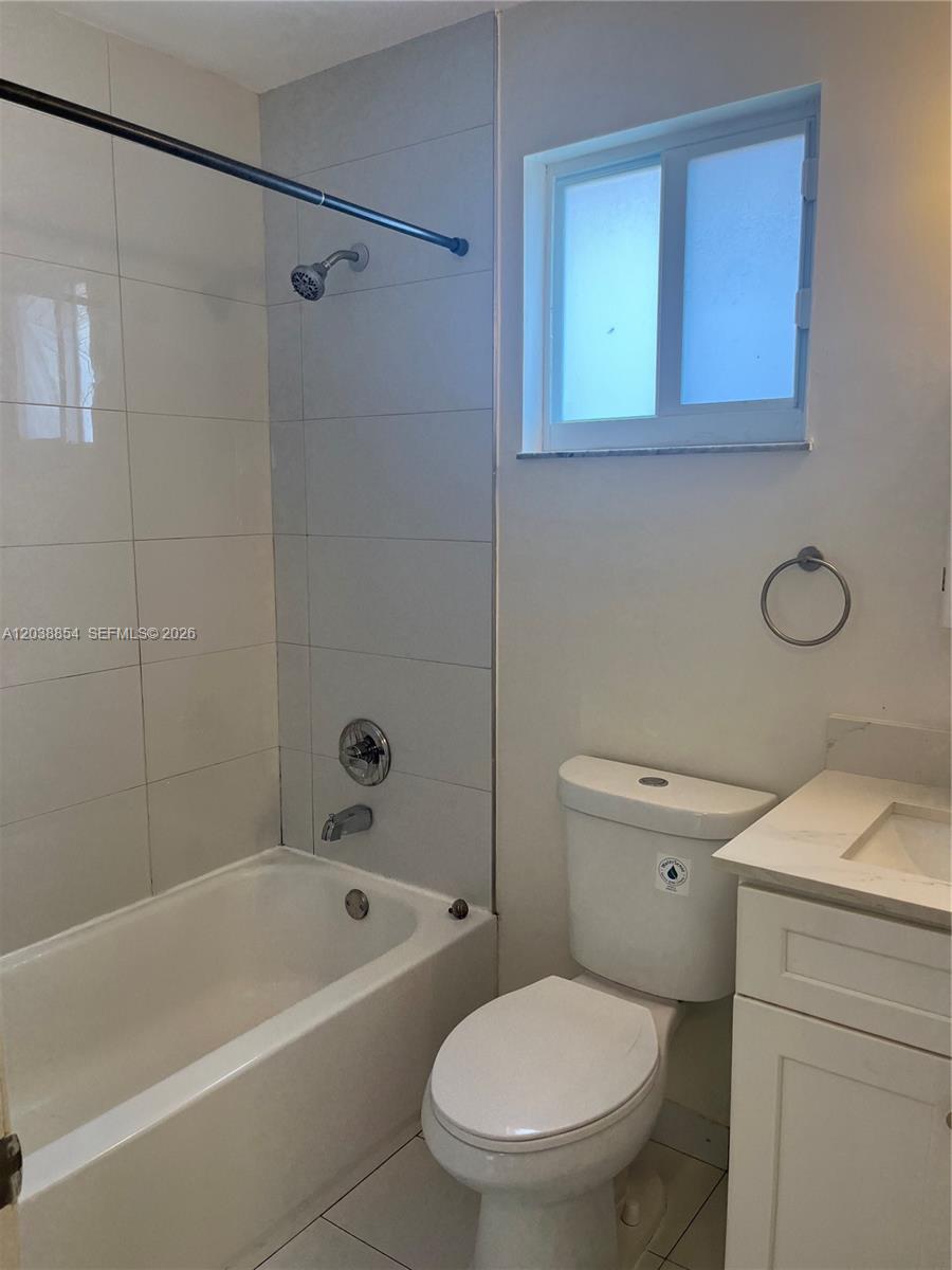 1419 Southwest 22nd Avenue Miami, FL 33145 - Photo 10 of 20 a bathroom with a toilet a sink a mirror and bathtub