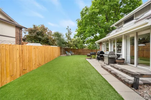 a backyard of a house with table and chairs