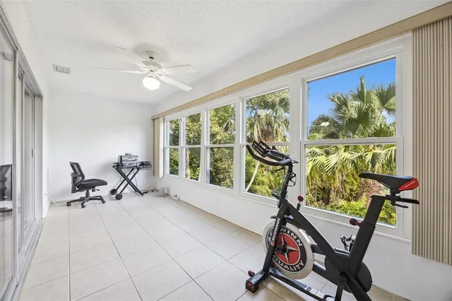 a living room with furniture a window and gym equipment