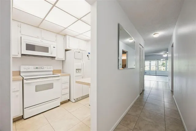 a kitchen with stainless steel appliances a refrigerator sink and cabinets