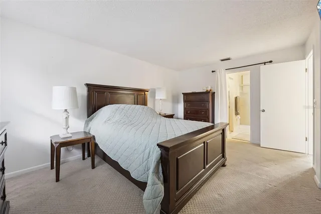 a living room with a bed furniture and a flat screen tv