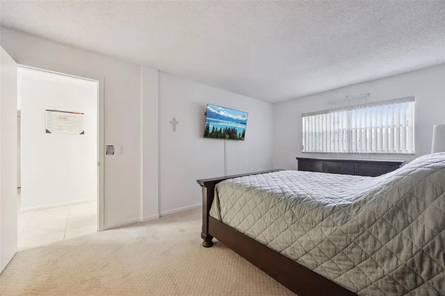 a bedroom with a bed and a painting on the wall