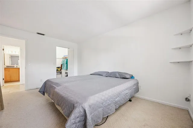 a bedroom with a bed and flowerpot