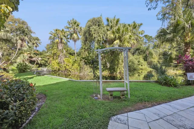 a garden with a bench in the garden