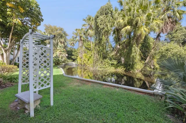 a view of a chair and table in the garden