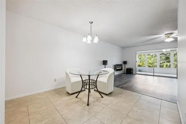 a view of a dining room with furniture and a chandelier