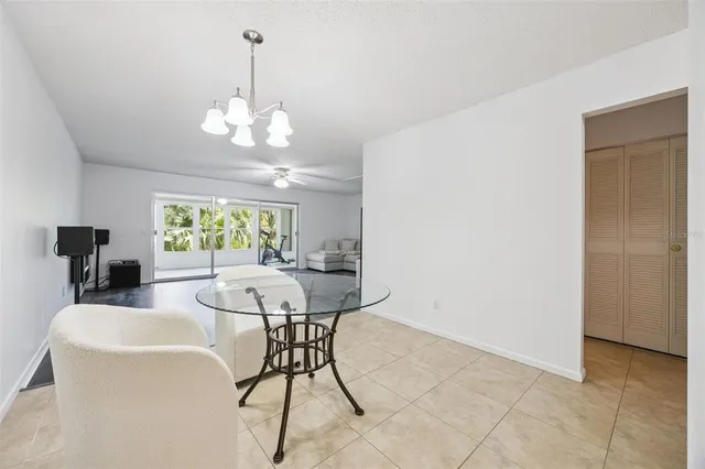 a view of a dining room with furniture and a chandelier