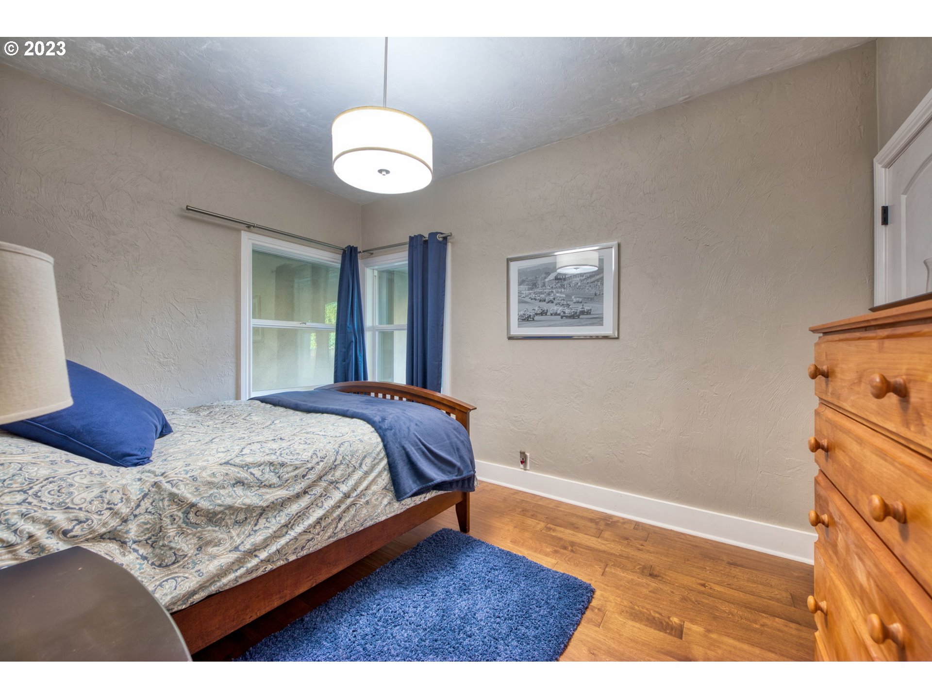 315 Ayres Road Eugene, OR 97408 - Photo 23 of 31 a bedroom with a bed and wooden floor