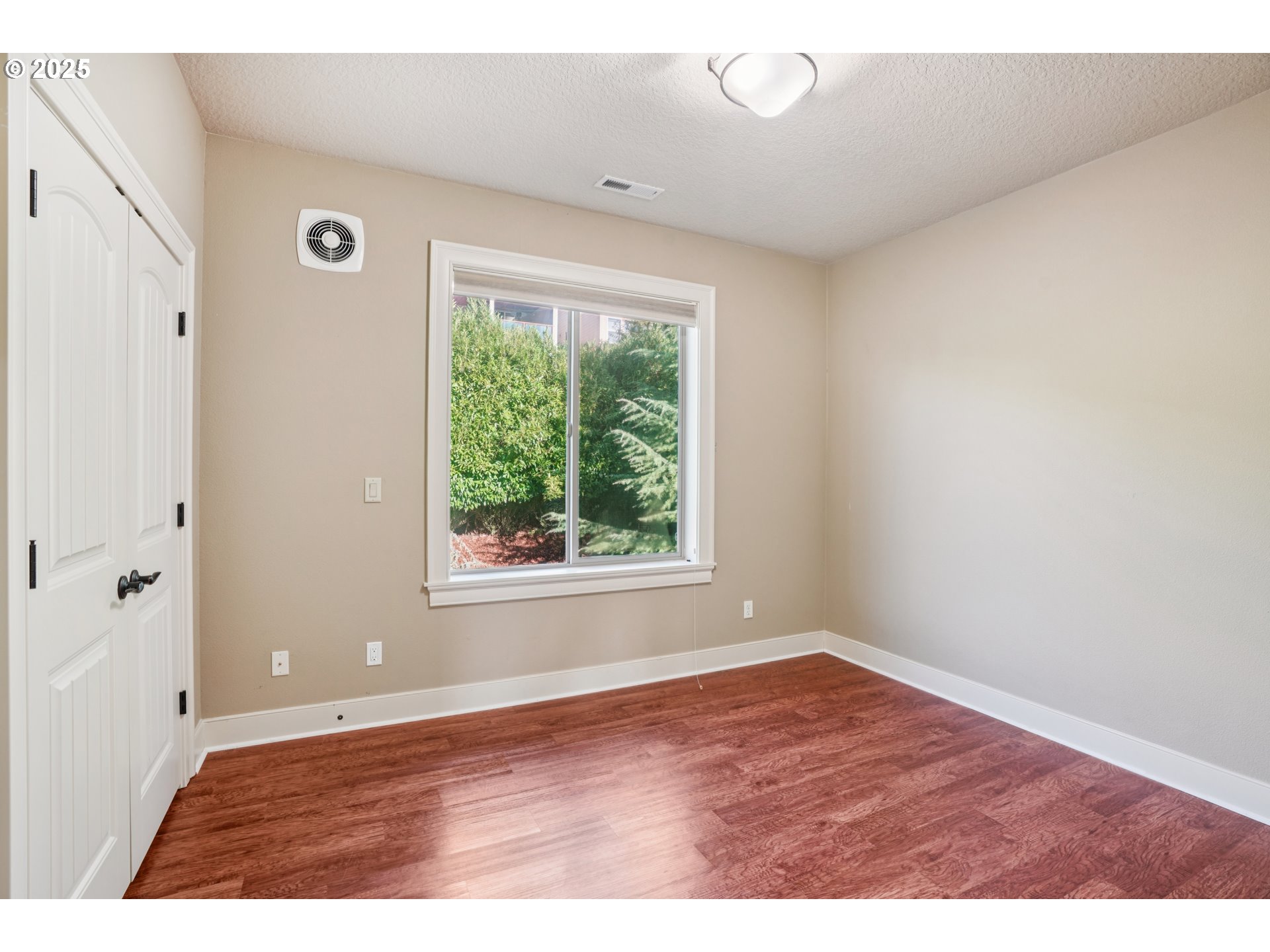 795 West X Street Washougal, WA 98671 - Photo 25 of 41 a view of an empty room with wooden floor and a window