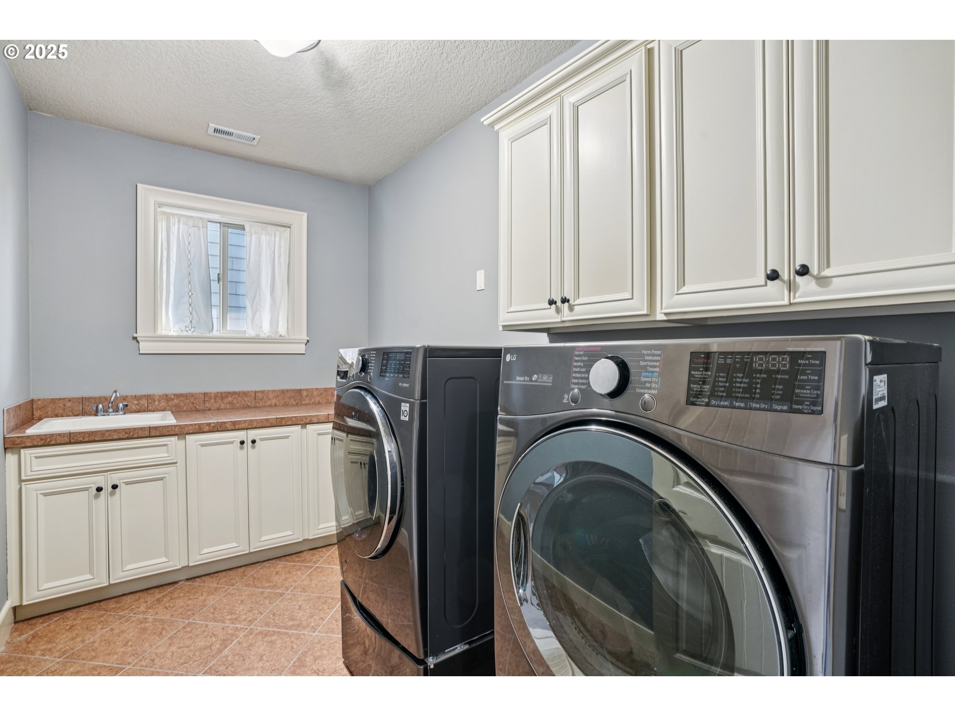 795 West X Street Washougal, WA 98671 - Photo 31 of 41 a utility room with granite countertop a sink a washer and dryer