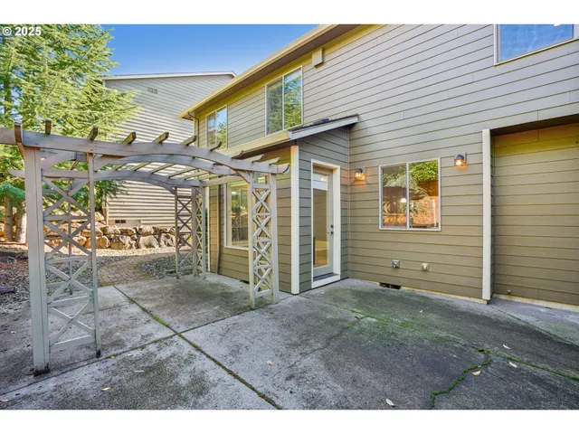 a backyard of a house with table and chairs