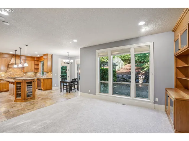 a living room with furniture a flat screen tv and floor to ceiling window