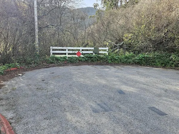 a pathway of a house with a yard