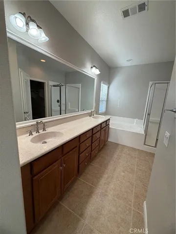 a bathroom with a granite countertop sink a mirror and shower