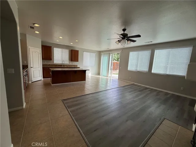 an open kitchen with refrigerator and microwave