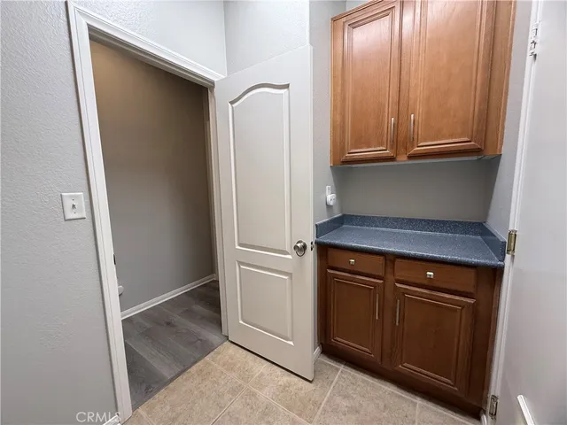 a kitchen with a refrigerator and cabinets