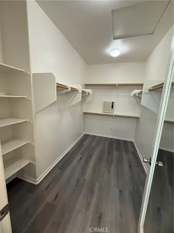 a view of walk in closet with empty racks