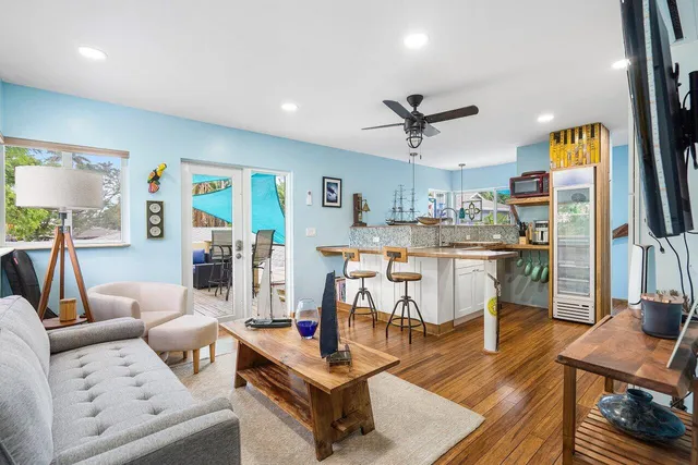 a living room with furniture and wooden floor
